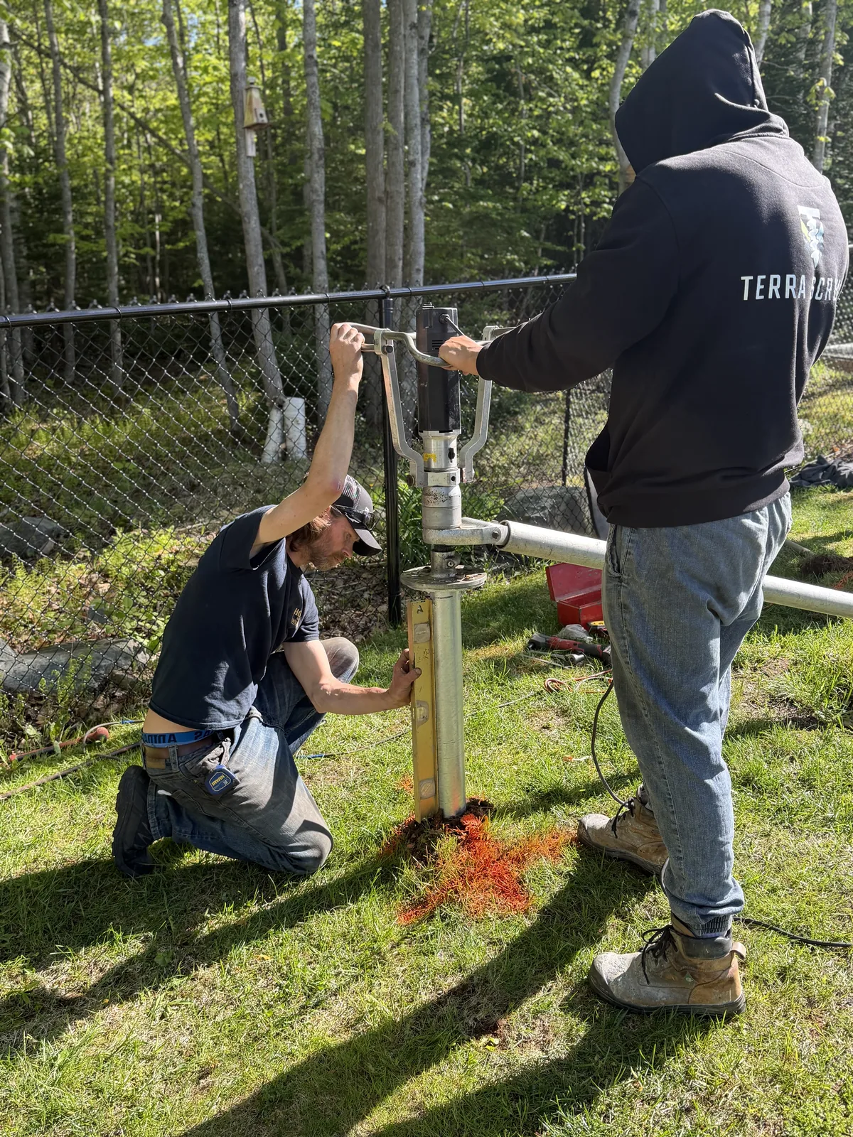 Two Terra Screws crew members setting a pile to line and level