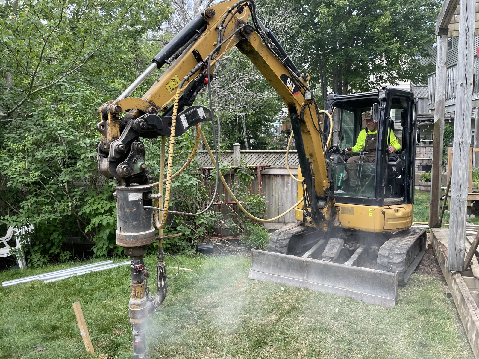 Ground screw pile driven in a tight residential backyard
